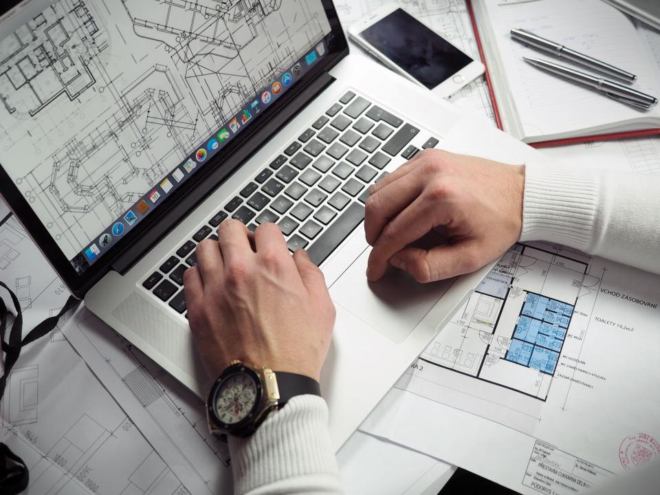 Planning a website on paper with a notebook at a desk